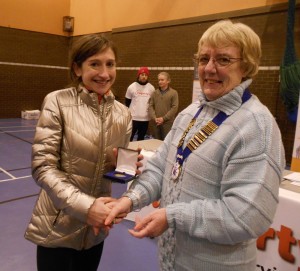 1st Lady Rebecca Robinson receives her medal from Northern Athletics President Jean Simpson