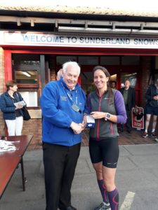 Emma Holt winner of NA 2017 5k Road Running Championship with past NA President Bill McGuirk